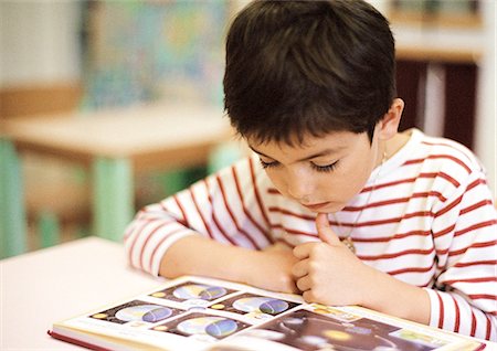 Child reading, close-up Stock Photo - Premium Royalty-Free, Code: 695-05776434