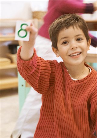 simsearch:695-05776481,k - Child holding card, smiling Stock Photo - Premium Royalty-Free, Code: 695-05776439