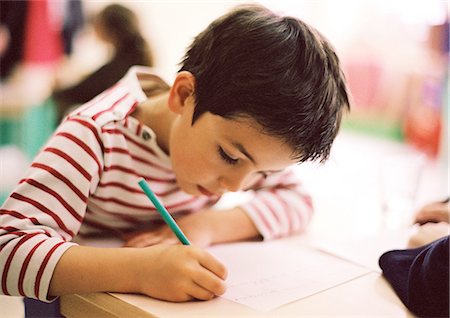 photo of boy sitting with his head down - Child writing, close-up Stock Photo - Premium Royalty-Free, Code: 695-05776433