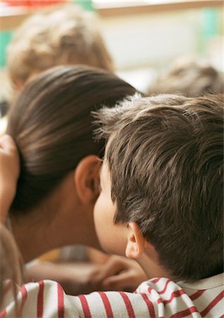 rear view of a boy bending over - Child kissing person's cheek, close-up, rear view Stock Photo - Premium Royalty-Free, Code: 695-05776484