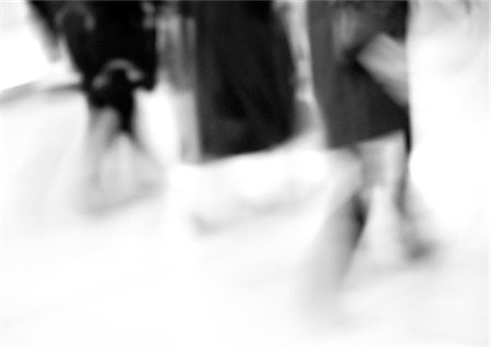 People walking, low section, blurred, b&w Stock Photo - Premium Royalty-Free, Code: 695-05776517