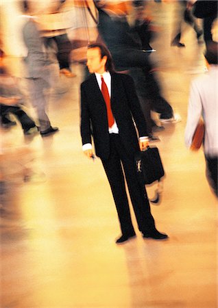 Businessman in crowd, blurred motion Stock Photo - Premium Royalty-Free, Code: 695-05776521