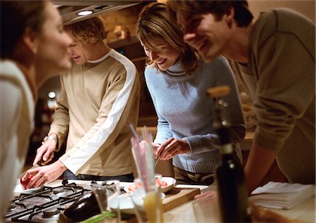 friends cooking together - People cooking together in kitchen Stock Photo - Premium Royalty-Free, Code: 695-05776639