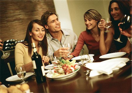 dinner party friends indoors young adults - Group of young people around table, drinking Stock Photo - Premium Royalty-Free, Code: 695-05776632