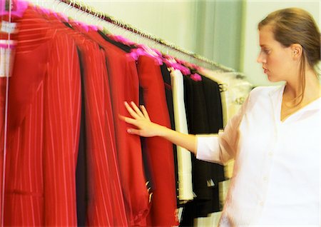 simsearch:649-07064922,k - Woman looking at jackets in clothing store. Foto de stock - Sin royalties Premium, Código: 695-05776712