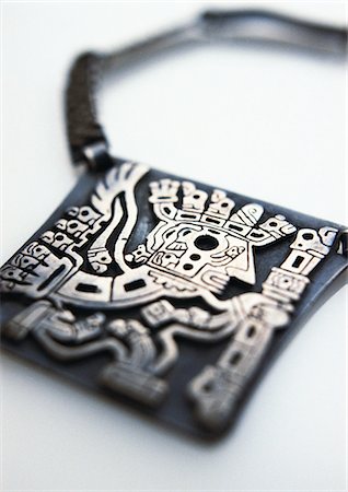 sun god - Carved silver amulet, close-up Stock Photo - Premium Royalty-Free, Code: 695-05776839