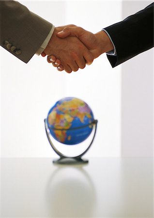 Two businessmen shaking hands above globe Stock Photo - Premium Royalty-Free, Code: 695-05776887