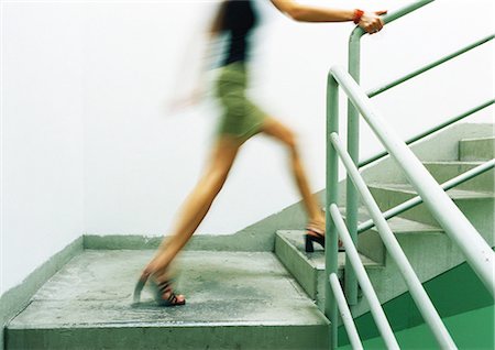 simsearch:695-05764648,k - Woman walking up stairs, blurred Foto de stock - Sin royalties Premium, Código: 695-05776943