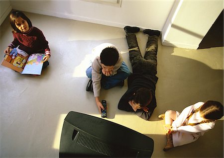 simsearch:632-01149451,k - Young boys and girls sitting on floor watching TV, high angle view Stock Photo - Premium Royalty-Free, Code: 695-05777060