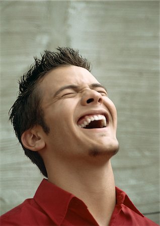Teenage boy laughing, head back, eyes closed, portrait Stock Photo - Premium Royalty-Free, Code: 695-05777138