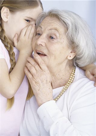 seniors and whispering - Girl whispering in grandmother's ear Stock Photo - Premium Royalty-Free, Code: 695-05777518