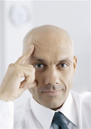 simsearch:695-05777565,k - Businessman with fingers on face and forehead, portrait Foto de stock - Royalty Free Premium, Número: 695-05777560