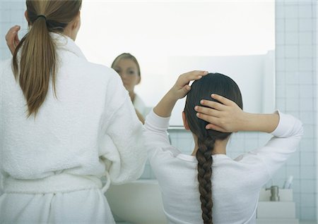 fixing hair - Woman and girl fixing hair, rear view Stock Photo - Premium Royalty-Free, Code: 695-05777652