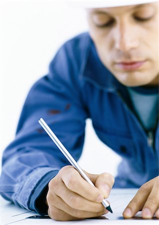 Homme dans une combinaison d'écriture sur les plans Photographie de stock - Premium Libres de Droits, Code: 695-05777798