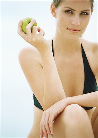 portrait picture adam and eve - Young woman in bikini holding apple, looking at camera Stock Photo - Premium Royalty-Free, Code: 695-05777872