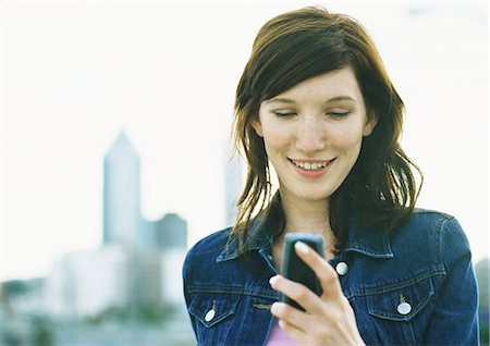 simsearch:632-02745019,k - Young woman holding cell phone Stock Photo - Premium Royalty-Free, Code: 695-05777984