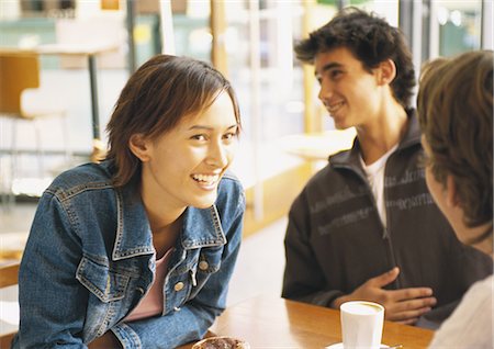 simsearch:695-03383828,k - Group of young people sitting at table in café, smiling Stock Photo - Premium Royalty-Free, Code: 695-05778020