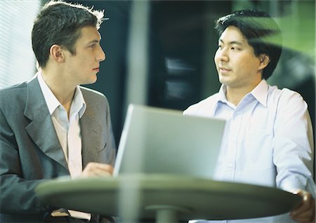 Two businessman staring at each other Stock Photo - Premium Royalty-Free, Code: 695-05778222