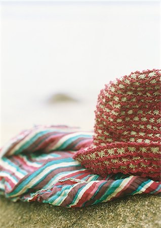 Sunhat and clothing on beach, close-up Stock Photo - Premium Royalty-Free, Code: 695-05778381