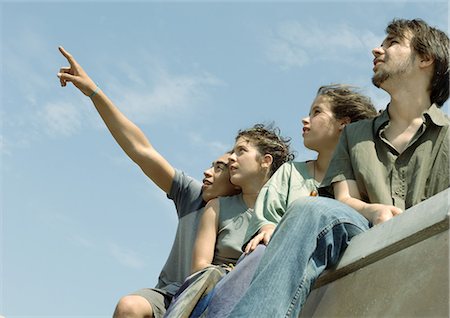 simsearch:628-02198065,k - Four young friends standing, looking up at sky Stock Photo - Premium Royalty-Free, Code: 695-05778565