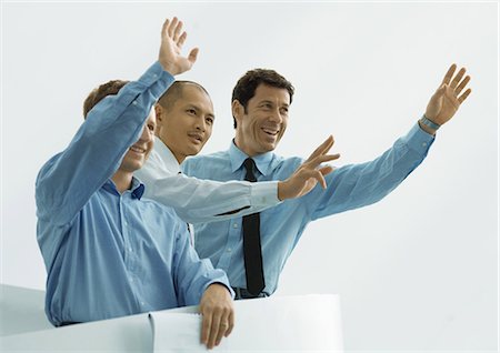 Three businessmen waving Stock Photo - Premium Royalty-Free, Code: 695-05778581