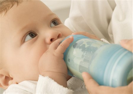 drinking milk with mom - Baby drinking from bottle, close-up Stock Photo - Premium Royalty-Free, Code: 695-05778624