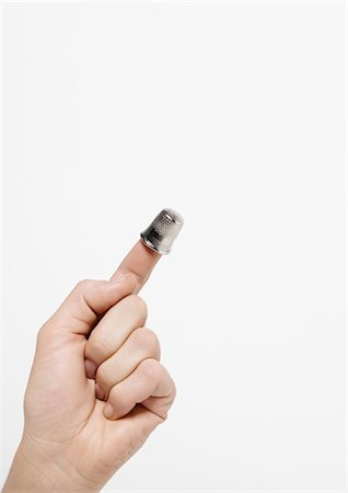 Hand with thimble on forefinger Stock Photo - Premium Royalty-Free, Code: 695-05778679