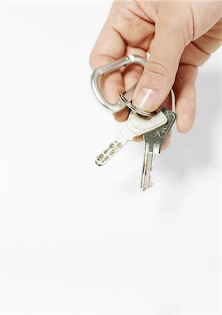 finger holding a key - Hand holding keys Foto de stock - Sin royalties Premium, Código: 695-05778686