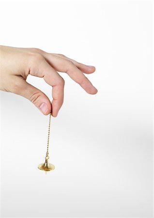 pendule (balancier) - Hand holding pendulum Foto de stock - Sin royalties Premium, Código: 695-05778682