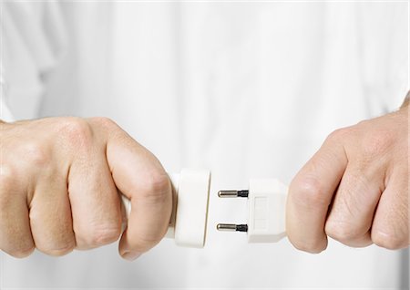 Hands plugging in electrical cord Stock Photo - Premium Royalty-Free, Code: 695-05778717