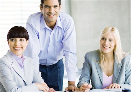 simsearch:632-07674588,k - Three businesspeople in meeting, smiling Stock Photo - Premium Royalty-Free, Code: 695-05778808