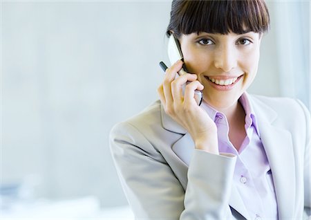 phone in front of face - Businesswoman using cell phone Stock Photo - Premium Royalty-Free, Code: 695-05778809