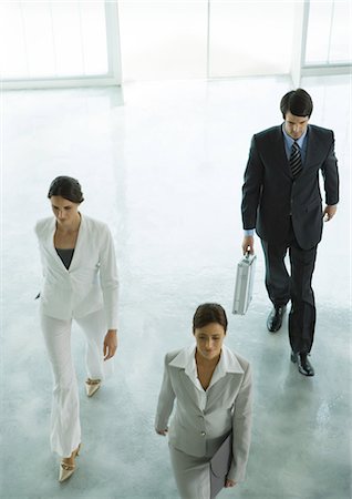 Three executives entering office building lobby Stock Photo - Premium Royalty-Free, Code: 695-05778846