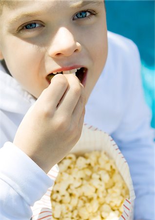 popcorn top view - Child eating popcorn Stock Photo - Premium Royalty-Free, Code: 695-05778992