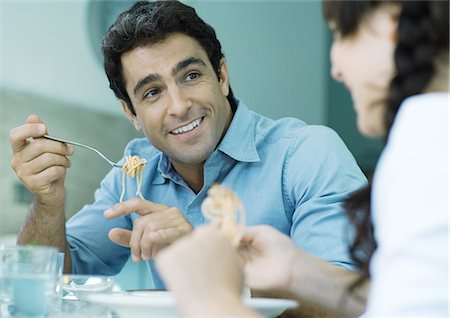 family around a table eating pasta - Father and daughter eating pasta Stock Photo - Premium Royalty-Free, Code: 695-05779033