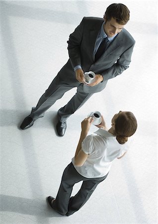 Office employees standing with coffee cups, full length, high angle view Foto de stock - Sin royalties Premium, Código: 695-05779081