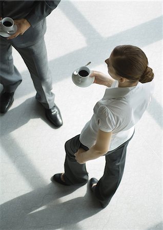 Office employees standing with coffee cups, high angle view Stock Photo - Premium Royalty-Free, Code: 695-05779082