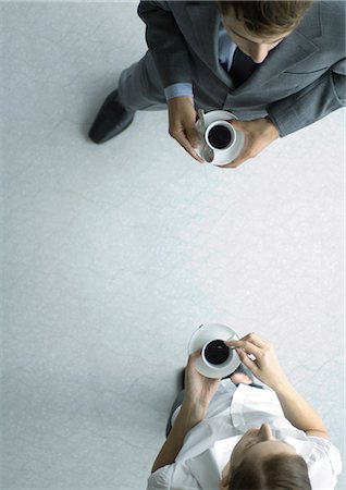 Office employees standing with coffee cups, view from directly above Foto de stock - Sin royalties Premium, Código: 695-05779083