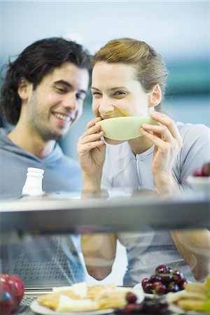 Young adults in exercise clothing, having snack in health club cafeteria Stock Photo - Premium Royalty-Free, Code: 695-05779099