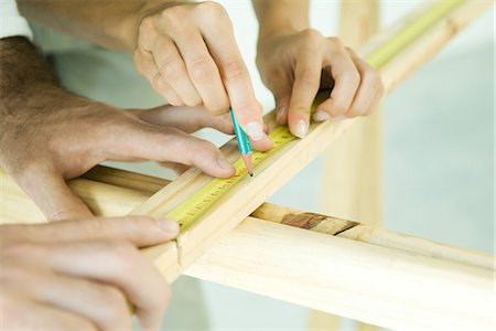 simsearch:695-03389240,k - Couple measuring wood with measuring tape, cropped view of hands Stock Photo - Premium Royalty-Free, Code: 695-05779209