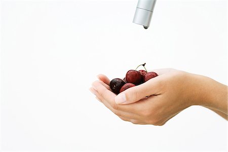 dripping faucet - Woman holding handful of cherries under faucet, cropped view of hands Stock Photo - Premium Royalty-Free, Code: 695-05779265