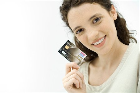 Woman holding credit card, smiling at camera Stock Photo - Premium Royalty-Free, Code: 695-05779331