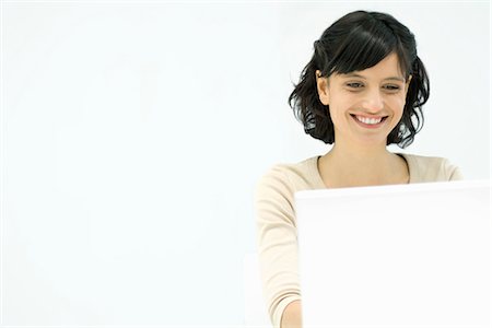 simsearch:633-02066083,k - Woman using laptop computer, smiling Stock Photo - Premium Royalty-Free, Code: 695-05779346