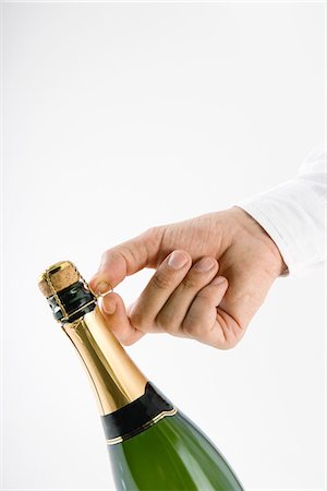 simsearch:695-05770345,k - Hand opening champagne bottle Foto de stock - Sin royalties Premium, Código: 695-05779399