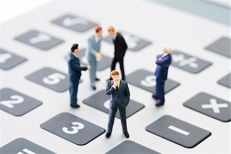 foresight concept - Miniature businessmen standing on calculator Stock Photo - Premium Royalty-Free, Code: 695-05779553