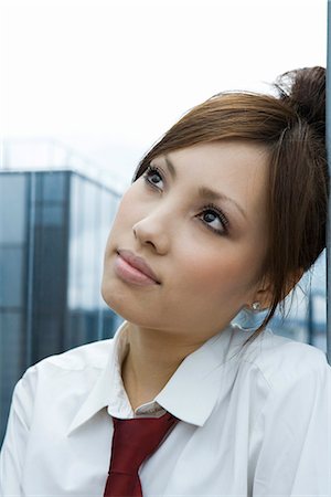 simsearch:695-03377755,k - Young female leaning head against wall, looking up, portrait Stock Photo - Premium Royalty-Free, Code: 695-05779637