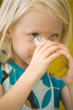 Little girl drinking glass of juice, close-up Stock Photo - Premium Royalty-Free, Code: 695-05779691