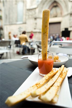 Breadstick dipped in sauce Stock Photo - Premium Royalty-Free, Code: 695-05779754