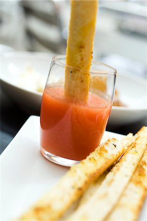 simsearch:695-05779754,k - Breadstick dipped in spicy sauce Foto de stock - Sin royalties Premium, Código: 695-05779781