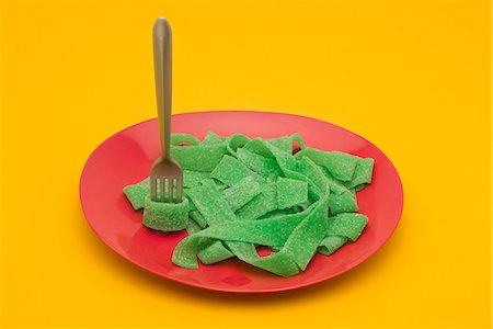 Food concept, plate of green gummy candy arranged like pasta Stock Photo - Premium Royalty-Free, Code: 695-05779934